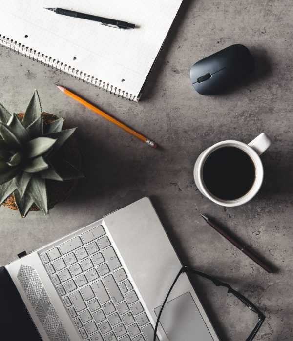 laptop and book, coffee on gray background, Top view of office desk on textured